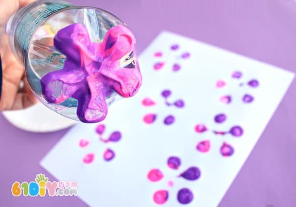 Baby painting with a bottle of beautiful flowers