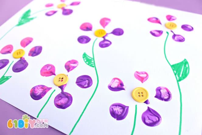Baby painting with a bottle of beautiful flowers