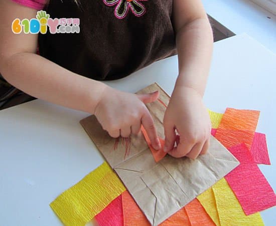 Toddler making Thanksgiving paper bag turkey