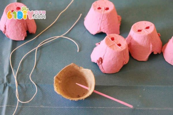 Children's handmade egg tray making pig nose