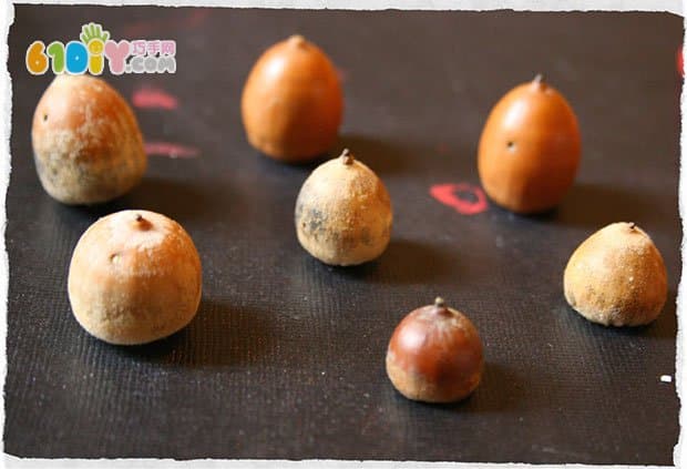 Young children use acorns to make small mushrooms