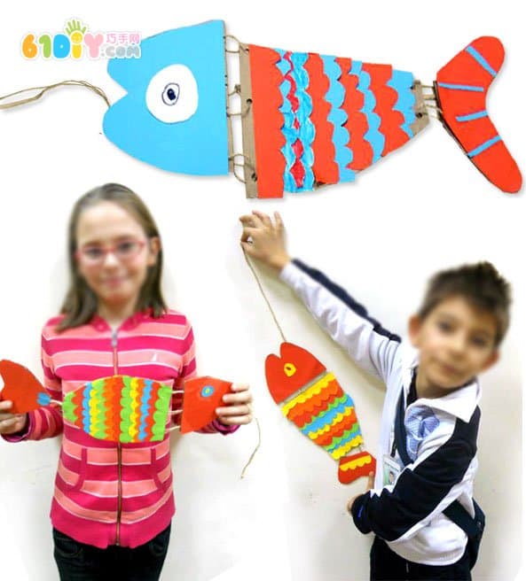 Children's handmade waste cardboard making fish ornaments