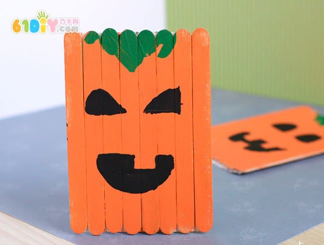 Children making Halloween pumpkins with ice cream sticks