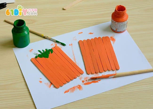 Children making Halloween pumpkins with ice cream sticks