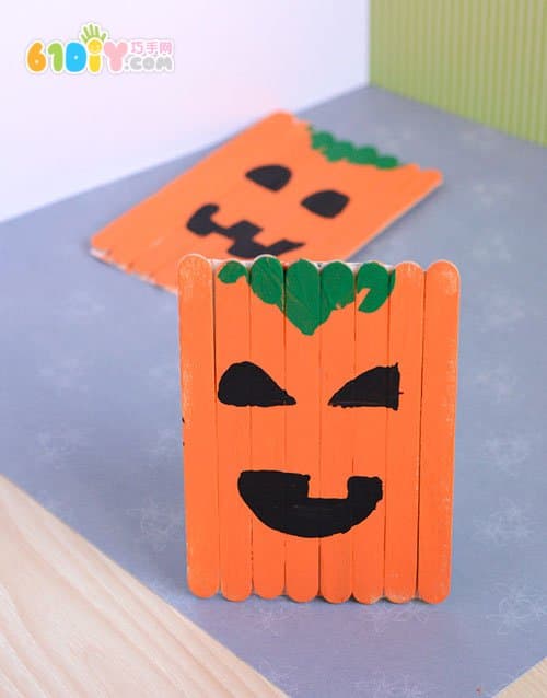 Children making Halloween pumpkins with ice cream sticks