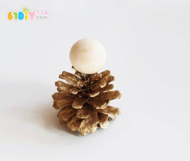 Making Christmas Elf ornaments with pine cones