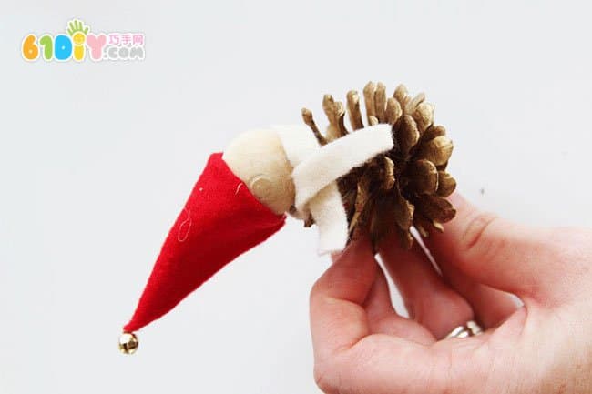 Making Christmas Elf ornaments with pine cones