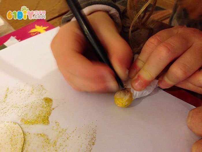 Children making wooden angels with wooden clips