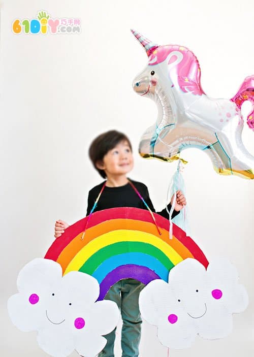 Large handmade waste cardboard making rainbow clouds