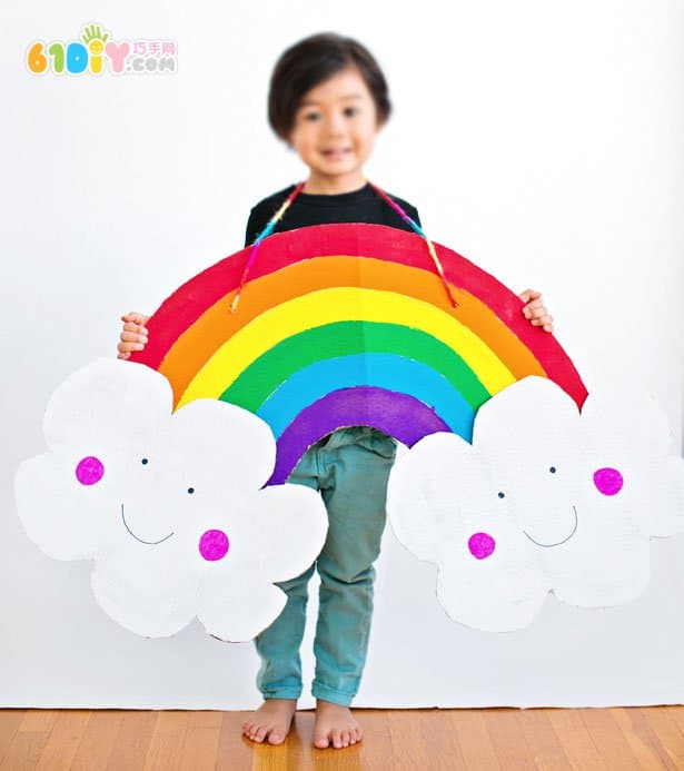 Large handmade waste cardboard making rainbow clouds