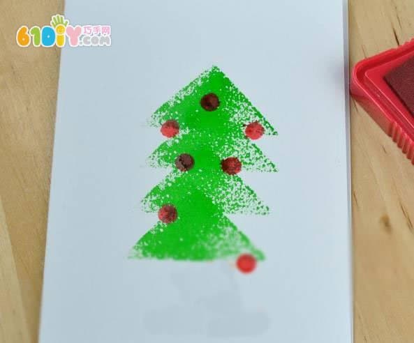 Toddler making beautiful seal Christmas tree greeting card