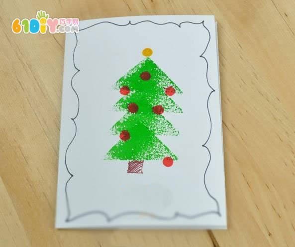 Toddler making beautiful seal Christmas tree greeting card