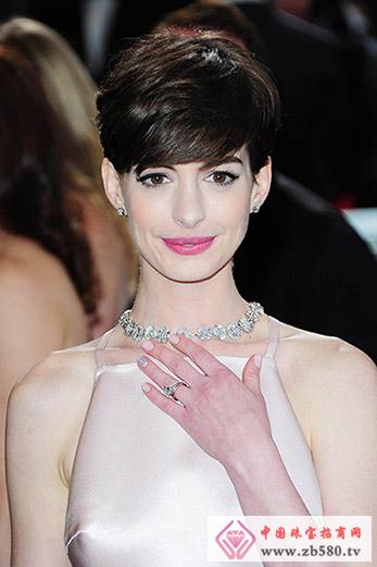 Anne Hathaway wears platinum and diamond necklaces, studs and bracelets on the red carpet
