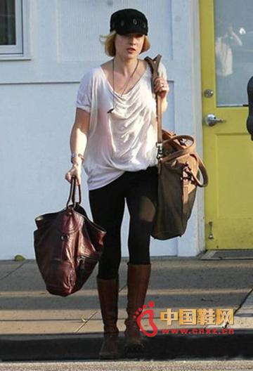 White blouse with black leggings and brown boots