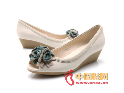 Lightweight mid-heeled wedge design with romantic flowers clustered around toe cap