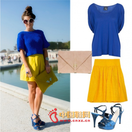 Dark blue short-sleeved knit sweater with a bright yellow skirt, matched with a pair of blue strappy high-heeled shoes