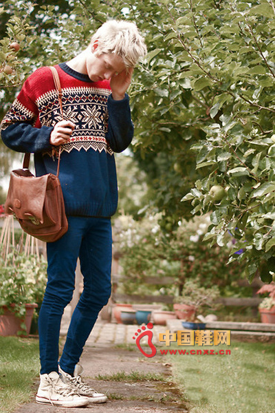 Simple dark blue sweater with classic snow pattern and red shoulder background