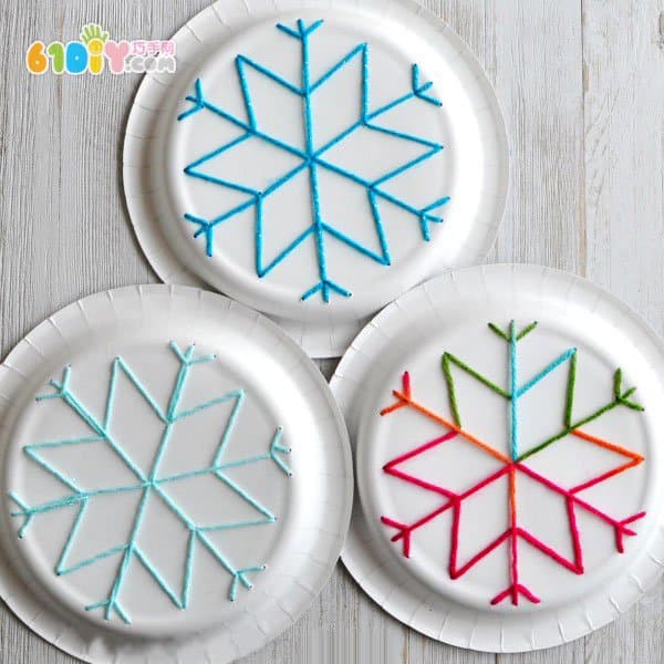 Children use paper plates to make snowflakes