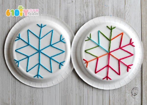 Children use paper plates to make snowflakes