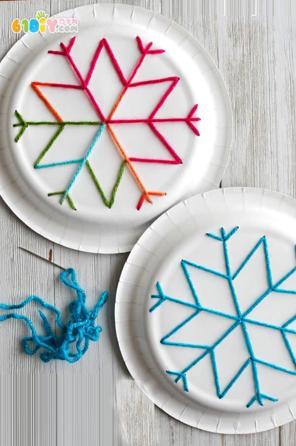 Children use paper plates to make snowflakes