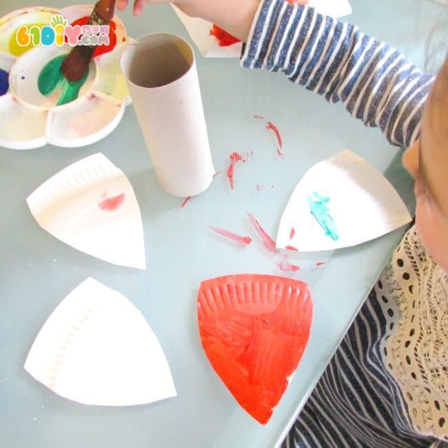 Children make colorful butterflies using paper trays