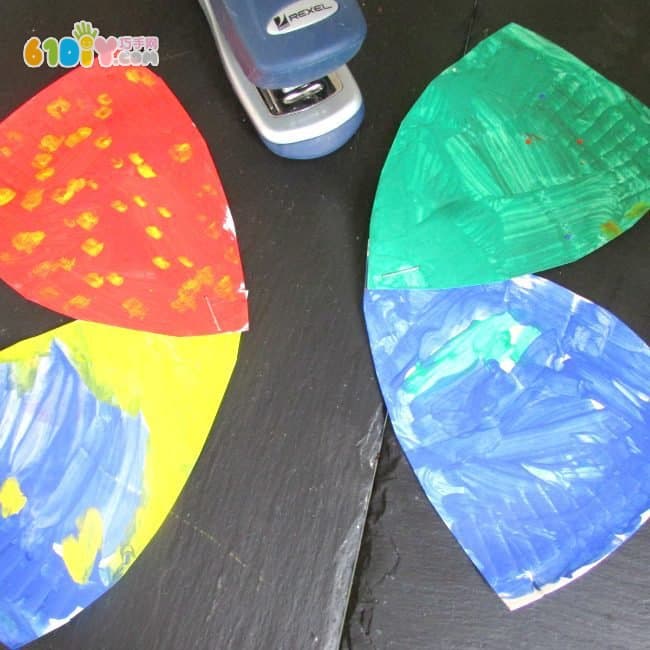 Children make colorful butterflies using paper trays