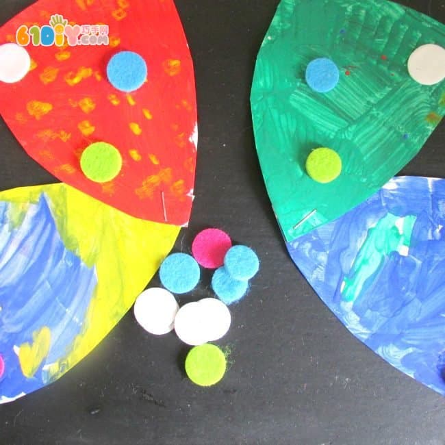 Children make colorful butterflies using paper trays