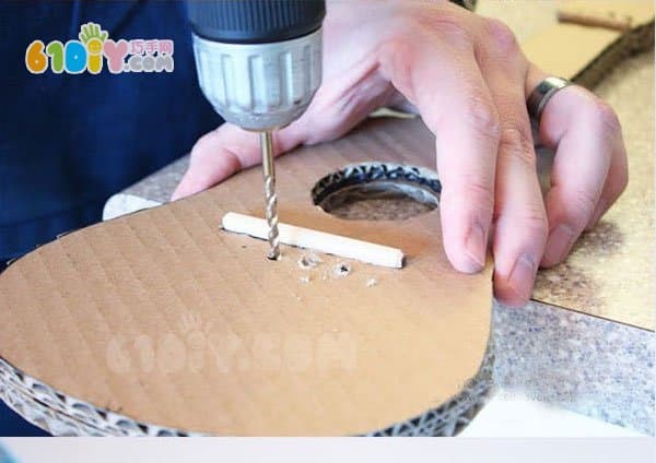 Waste cardboard making toy guitar