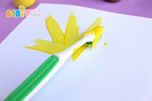 Child painting toothbrush painting sunflower