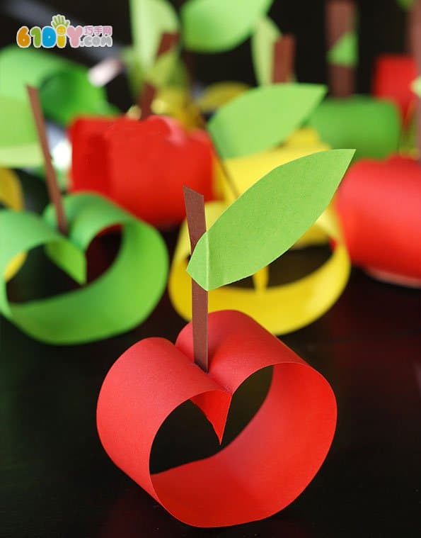 Child making stereo cardboard apple