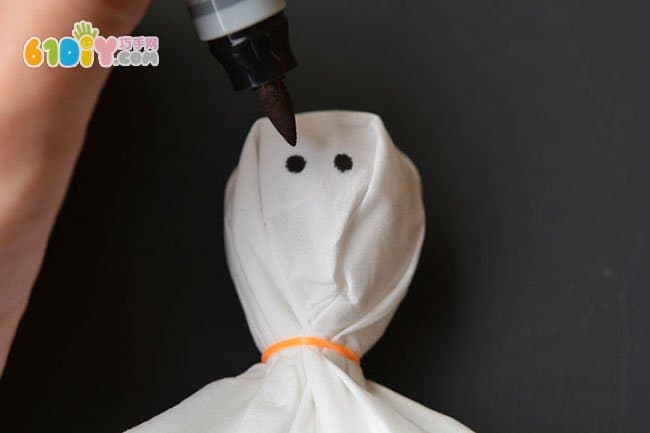 Parent-child making Halloween lollipop ghost