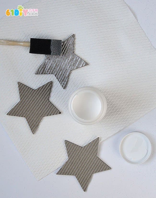 Children making Christmas shiny star ornaments