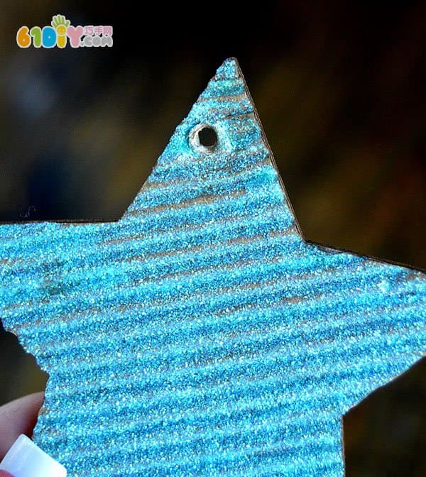 Children making Christmas shiny star ornaments