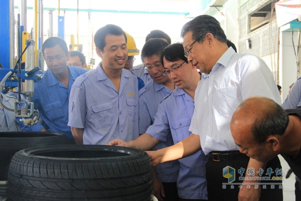 Lingxi Group Chairman Wang Xicheng (second from right) checks the first model tires