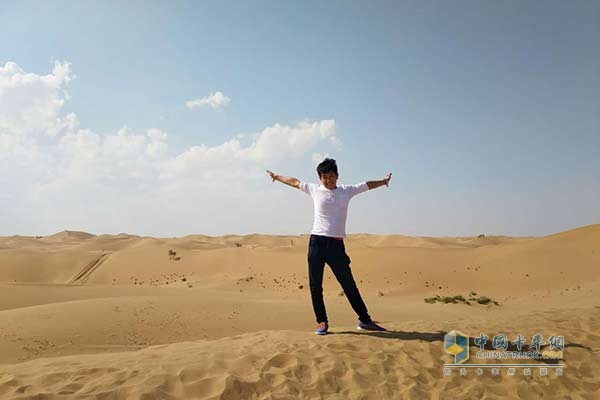 Wei Kai walks through the desert in the middle of a sports car