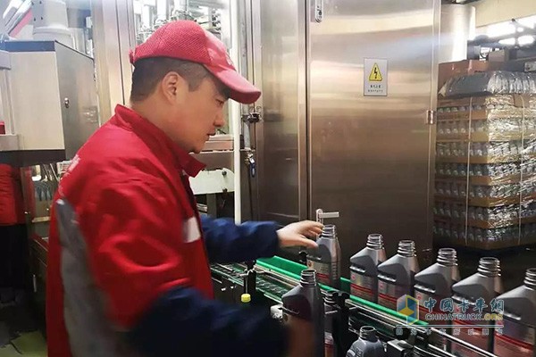 Workers working seriously in the zero kilometer lubricant factory