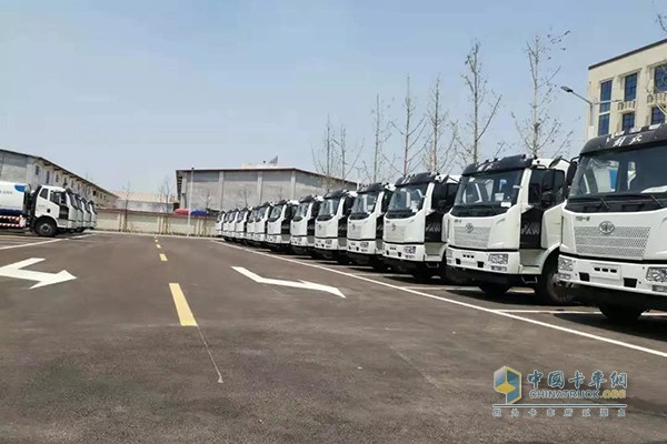 The vehicles are neatly arranged, waiting for delivery