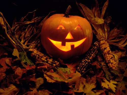 Witch mask, pumpkin lantern on Halloween shelf