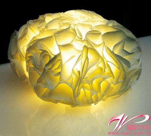 Layered curled paper craftsmanship creates a feminine lighting