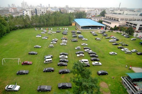 On September 8th, 2009, at the Yangzhou University in Jiangsu Province, on the first day of the freshman registration, hundreds of vehicles were driven into the campus and the playground became a parking lot. Most of them were parents who drove their children to report in addition to the cars they had given to their children. CFP