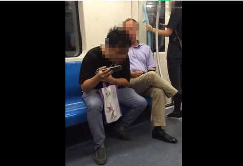 Caption: The man in the video ignored dissuasion and continued to spit. Video screenshot