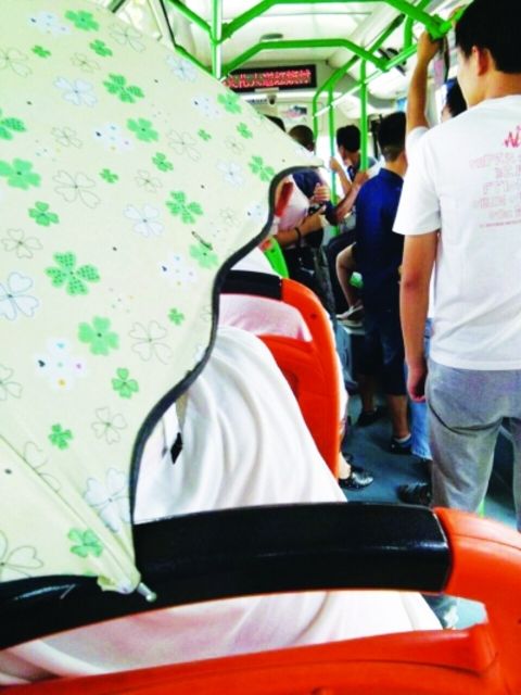 Couples hold up their umbrellas in the bus and affect other passengers.