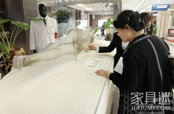 Customers look at mattresses in the mattress market