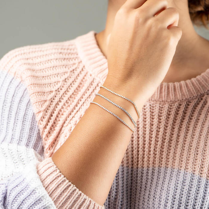 FLB-011 round lab diamond tennis bracelet shown with stacked slim bracelet proportions on wrist
