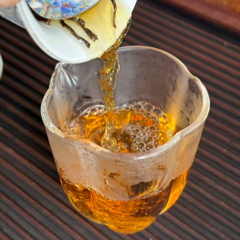 Golden amber tea liquor flow of brewed ancient tree sun dried black tea Golden amber tea liquor flow of brewed ancient tree sun dried black tea
