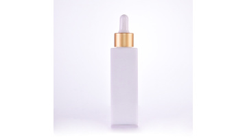 Opal white square bottle with golden dropper cap