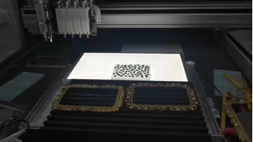 Diamond setting machine for irregular-shaped diamonds, dispensing adhesive on metal frames.