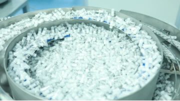 Automated machine production of airless bottles