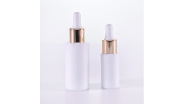 Cylinder white glass serum bottle with golden dropper