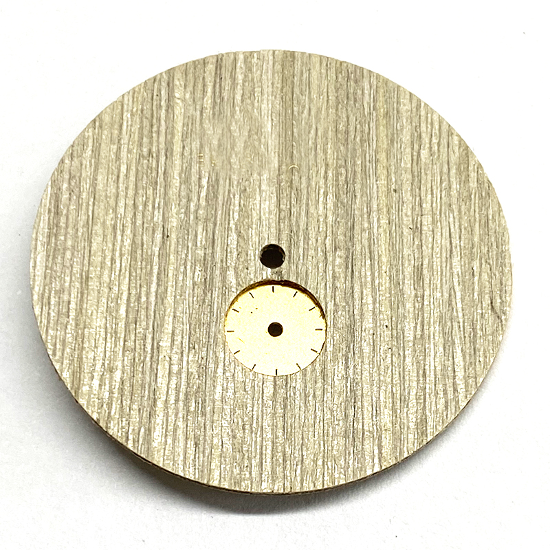Natural wood watch dial with small eye